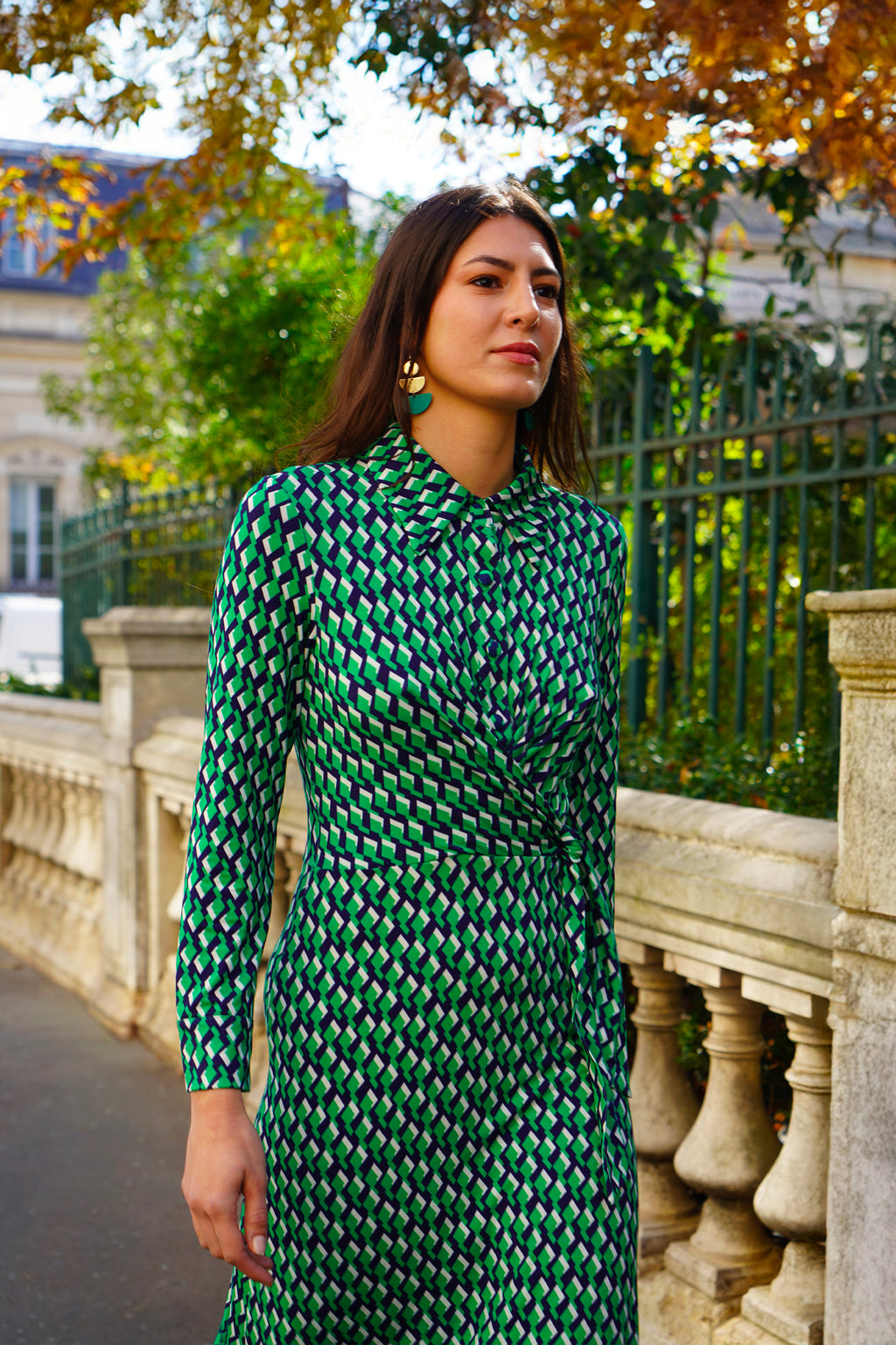 Robe mi-longue à la coupe fluide et moderne. Col chemisier et boutonnage caché. Drapé croisé sur le côté gauche pour une touche sophistiquée. Bas légèrement évasé.